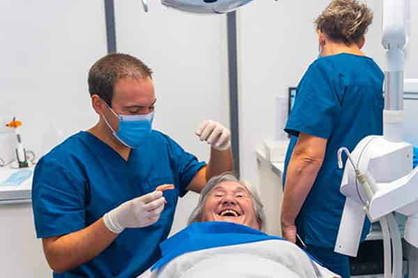 Dental procedure with medical professionals present.