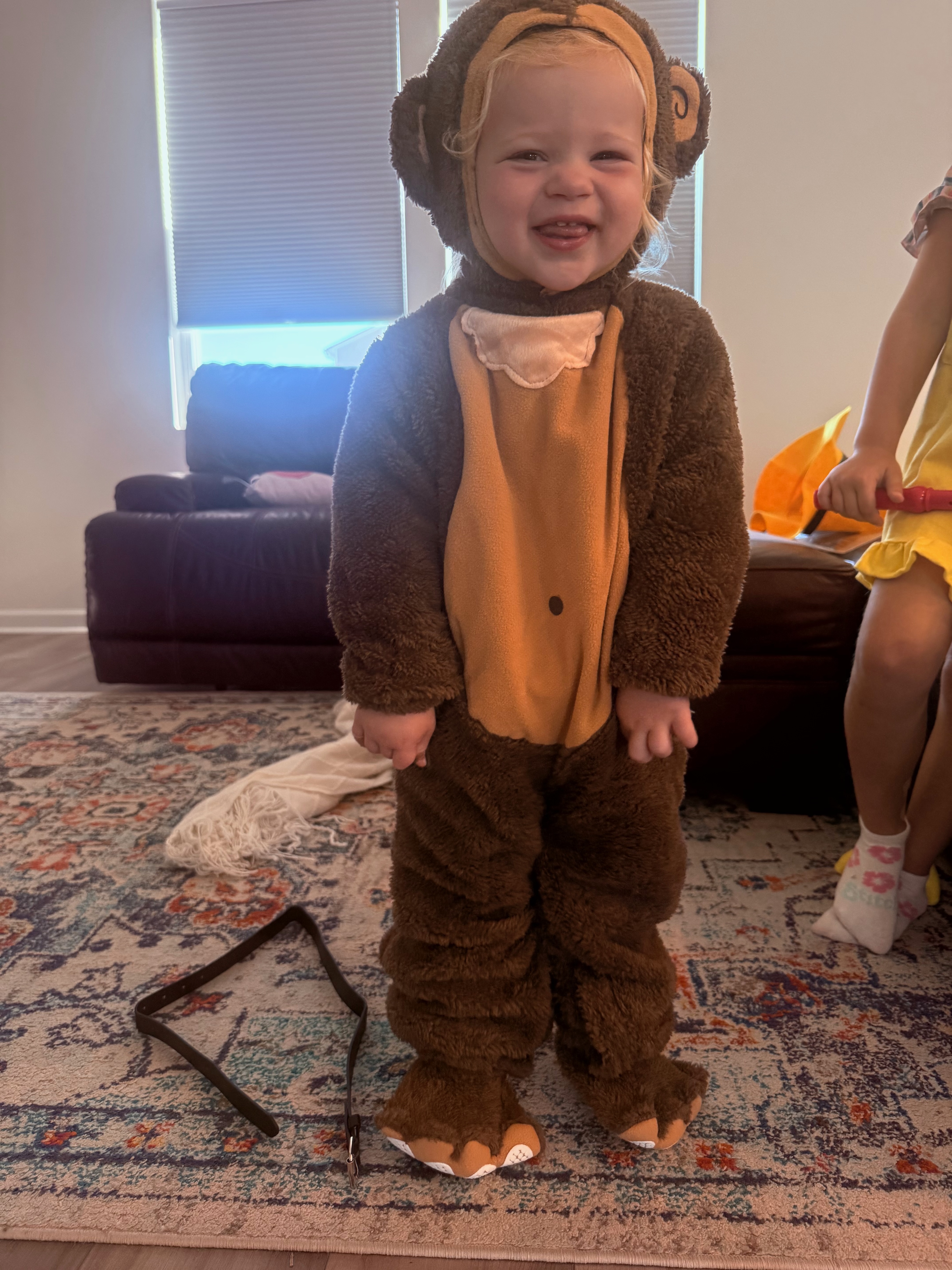 Ruby smiling wearing a curious george costume